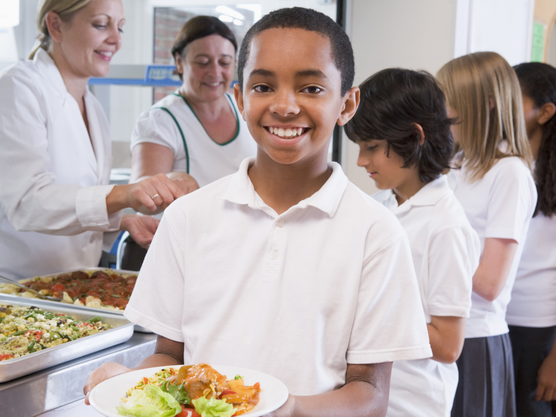 School child with healthy school lunch